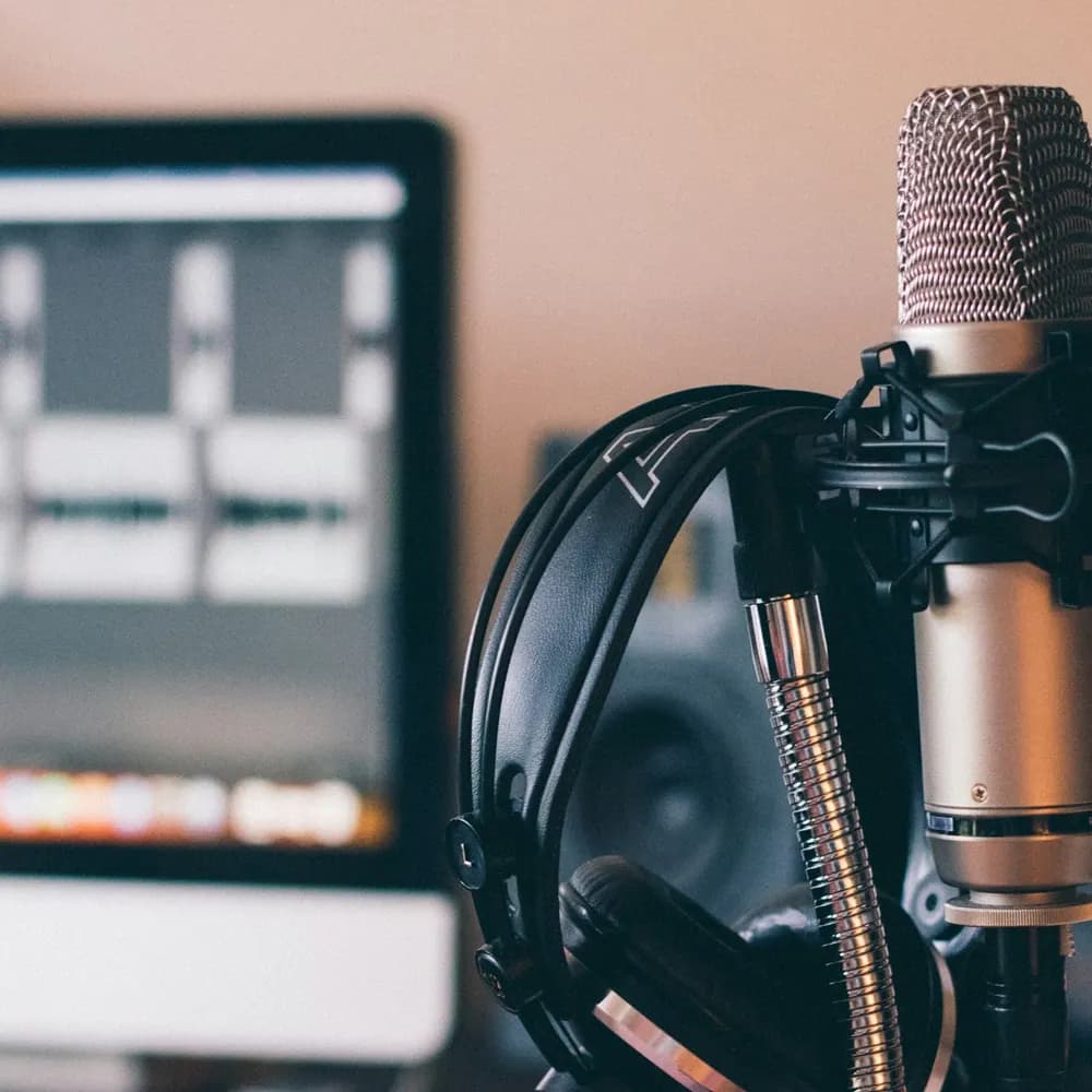 Aurora Studio USB desk microphone mounted on a boom arm at a recording desk
