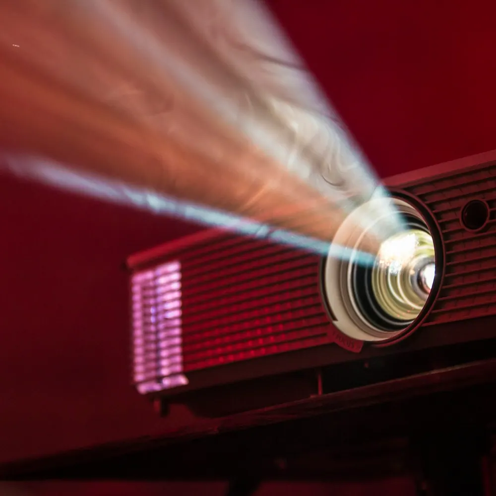 Lumen Beam portable projector casting an image on an outdoor screen